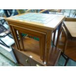 A nest of three mid-20th century Danish occasional tables one having a tiled top