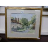 A framed and glazed watercolour of a village street scene,