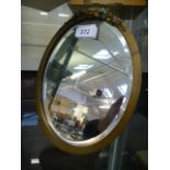 An early 20th century oval floral decorated easel mirror