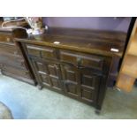 A continental oak effect cabinet having two drawers above cupboard doors