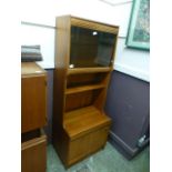 A teak glazed unit having open storage with door to base