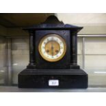 A Victorian black slate mantle clock