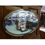 A silver framed oval bevelled glass mirror