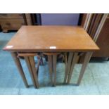 A mid-20th century teak occasional table incorporating three small drop leaf tables to under