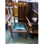 An early 20th century oak open arm chair