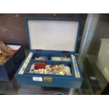 A jewellery box containing an assortment of costume jewellery to include necklaces, rings,