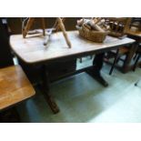 An early 20th century oak dining table on shaped end supports