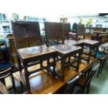 A set of four oak framed dining chairs with red leather upholstery and brass studs