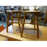 A pair of circular topped stools