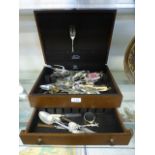 A mahogany canteen case with a selection of flatware