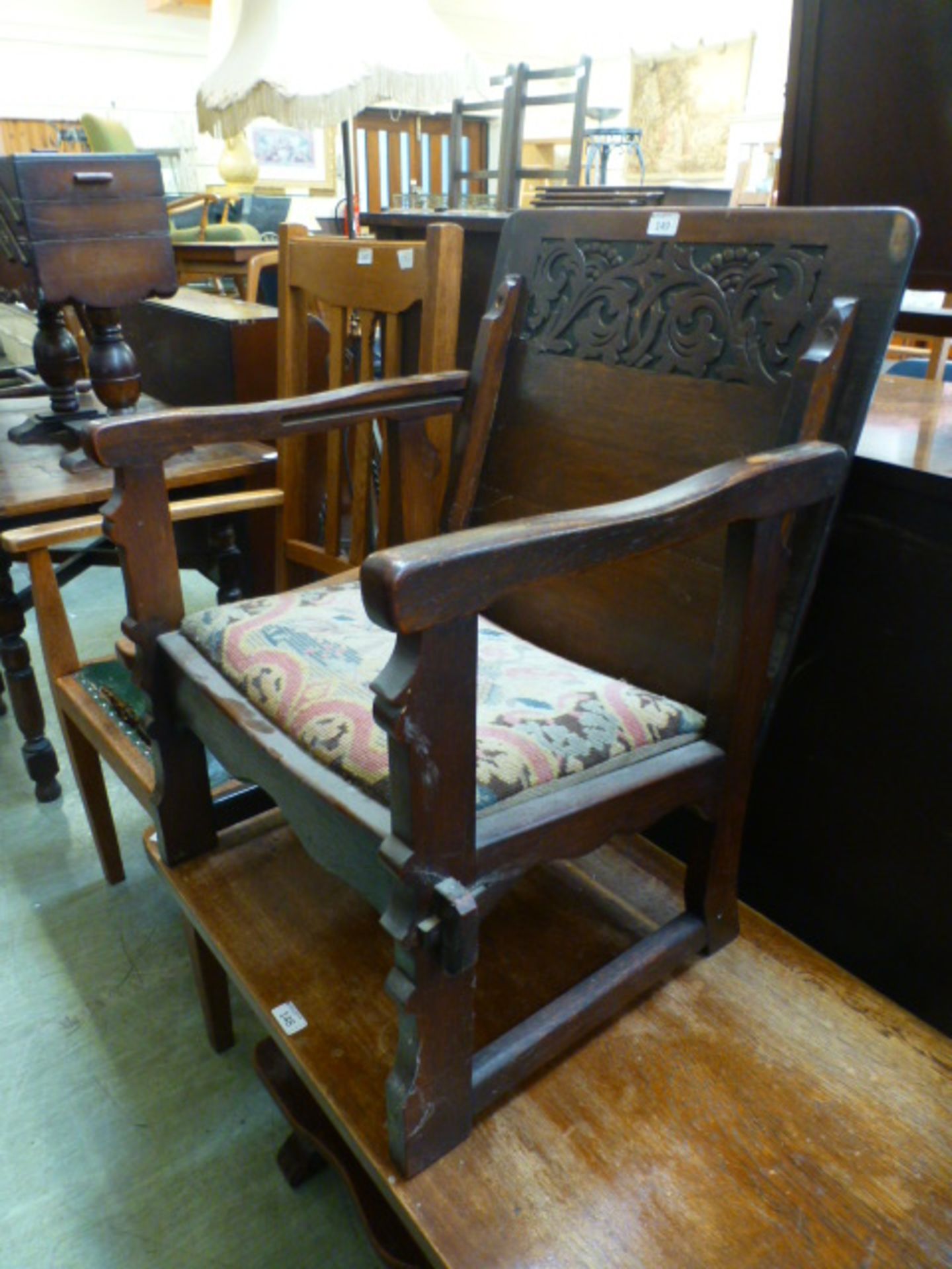 An early 20th century oak monks bench CONDITION REPORT: Split to top.