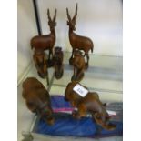 A selection of wooden carved animals to include rhino, monkeys etc.