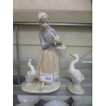 A Lladro model of a young girl with ducks together with on other Lladro duck