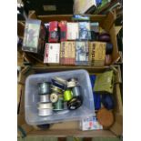 Two trays containing fishing reels, fishing line etc.