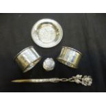 Two silver napkin rings together with a white metal patch box,