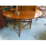 A mid-20th century design teak drop leaf dinning table