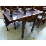 An early 20th century oak drawer leaf dining table