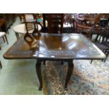 An early 20th century mahogany drop leaf table with floral carved border on cabriole legs