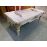 A cream painted low level rectangular table