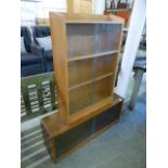 A mid-20th century oak bookcase with sliding glazed doors along with one other