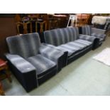 A mid-20th century design three piece suite comprising of a three seater sofa and a pair of