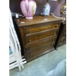 A reproduction oak effect four drawer chest of drawers
