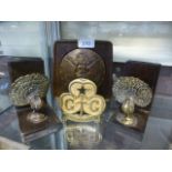 A pair of bookends with brass peacocks together with a brass Girl Guides flag pole topper and a