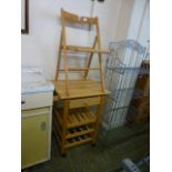 A beech kitchen island along with a beech folding chair