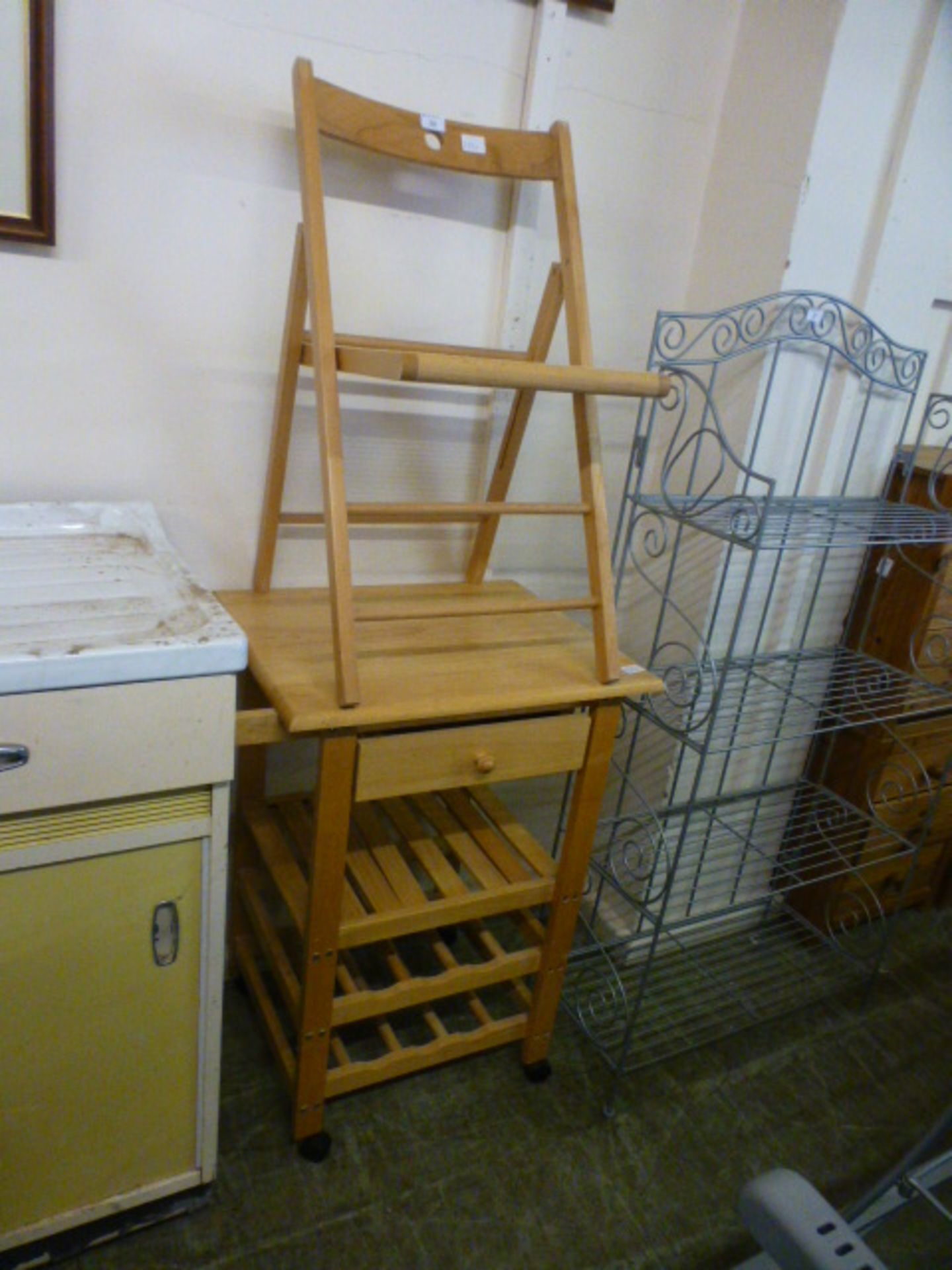 A beech kitchen island along with a beech folding chair