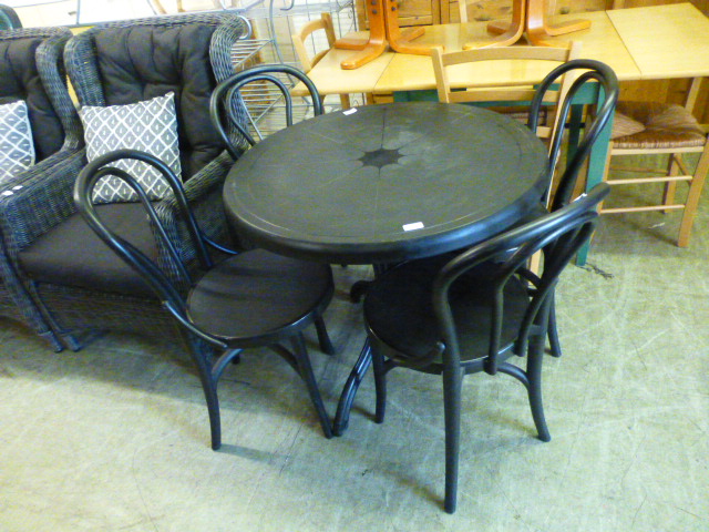 A black PVC garden table along with four matching chairs