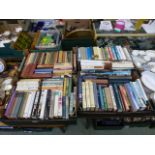 Four trays of hardback books by various authors