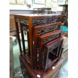 A Chinese padouk quartetto nest of tables with carved dragon frieze's