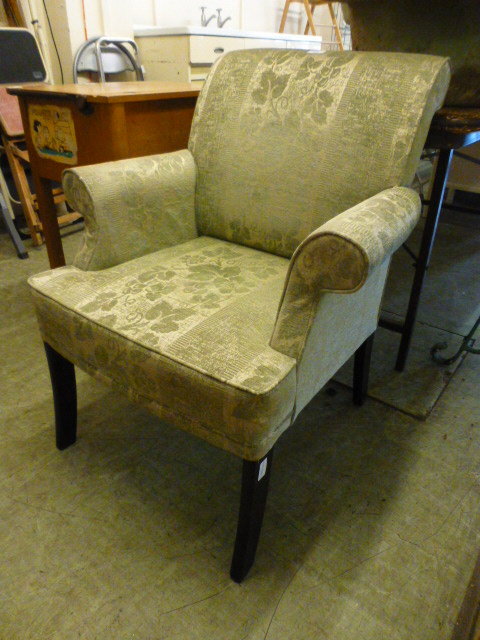 A Parker Knoll armchair upholstered in a floral gold fabric