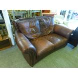 A blown leather and brass stud two seat sofa