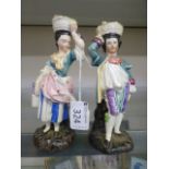 Two continental ceramic figures of a lady and boy carrying baskets