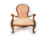 A Victorian walnut nursing chair upholstered in a faded pink button back fabric,