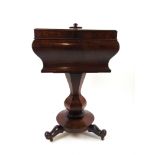 A William IV mahogany teapoy of sarcophagus form with bombe sides over a shaped hexagonal column,