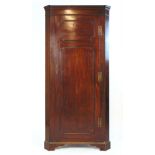 An 18th century and later mahogany floor standing corner cupboard, h. 198 cm, w.