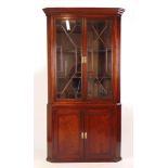 An 18th century style mahogany floor standing corner cupboard,