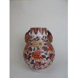 A 19th century Japanese imari vase, the body having floral decoration and animal head masks, h.