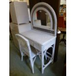 A white painted wicker dressing table with matching chair