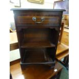 A reproduction mahogany cabinet having single drawer above open storage