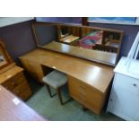 A mid-20th century teak dressing table with mirror and matching stool