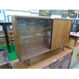 A mid-20th century design teak cabinet having a sliding glass door together with solid teak door