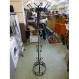 A modern metalwork coat stand with revolving hooks