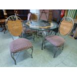 A modern circular metalwork based conservatory table with a set of four matching chairs