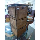 A metal framed wicker three drawer cabinet