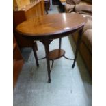 An Edwardian style mahogany oval topped occasional table with under tier on fluted tapering legs