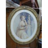 An ornate gilt framed oval print of young lady