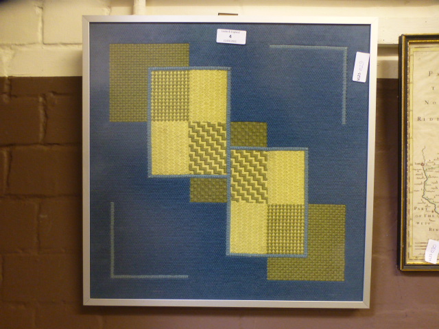 A framed and glazed mid 20th century geometric needlework